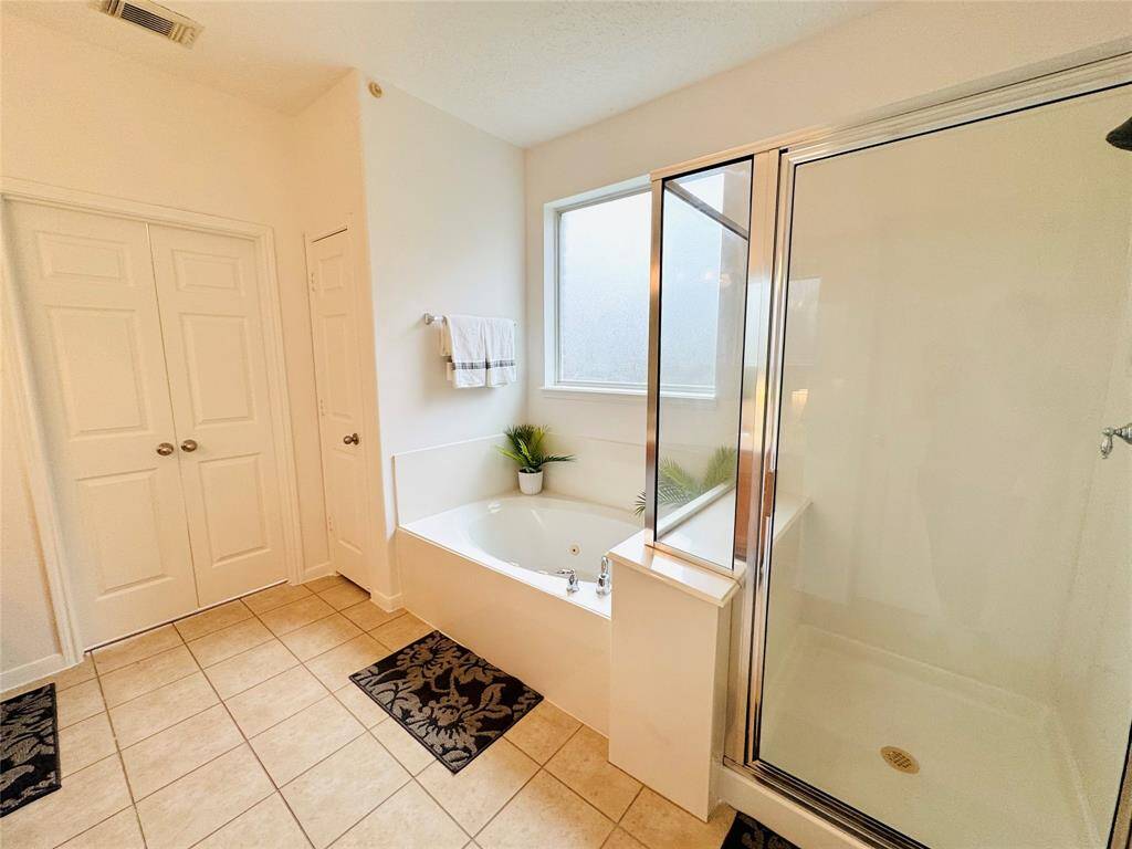 The neutral tile flooring and updated wall and trim creates a soothing space.