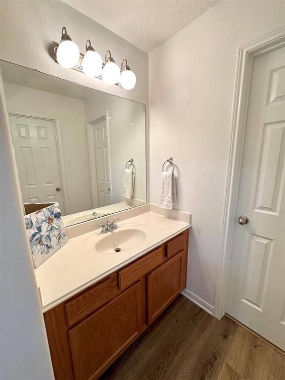 Adjacent vanity with a shared tub and toilet to the right! Enhanced photo.