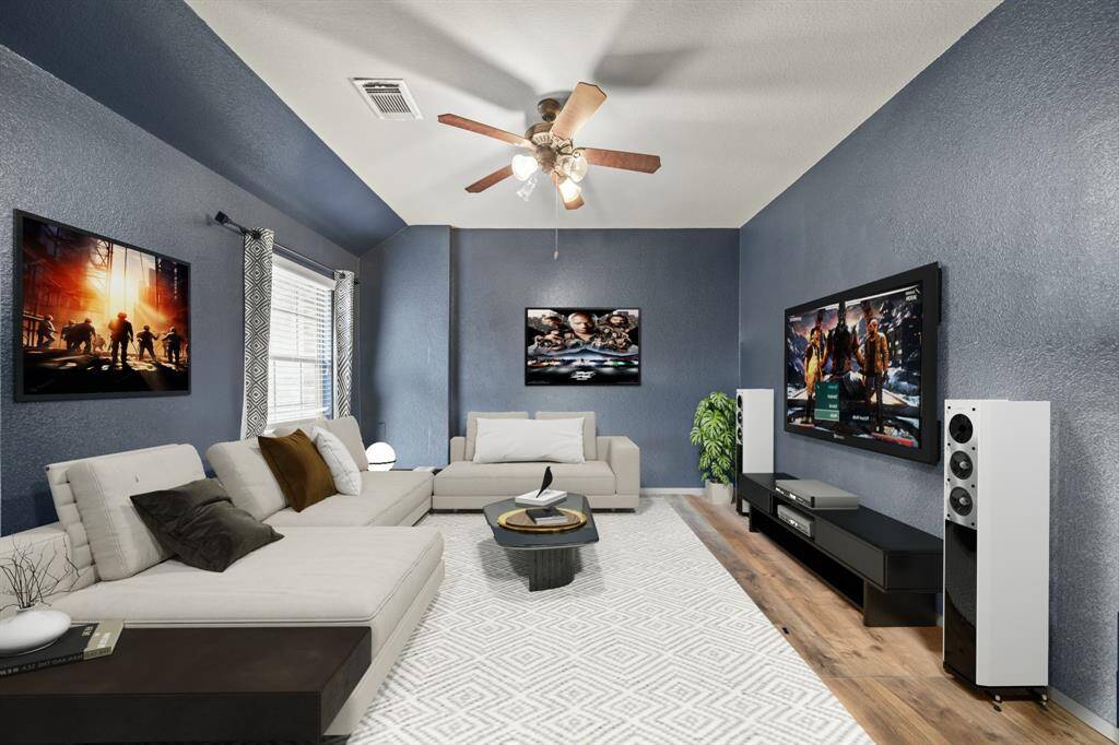 Virtually Staged: No need to go to the movie theater with this fantastic media room! Featuring wood floors, a window with privacy blinds, a ceiling fan, and vast space for the ultimate home viewing experience.