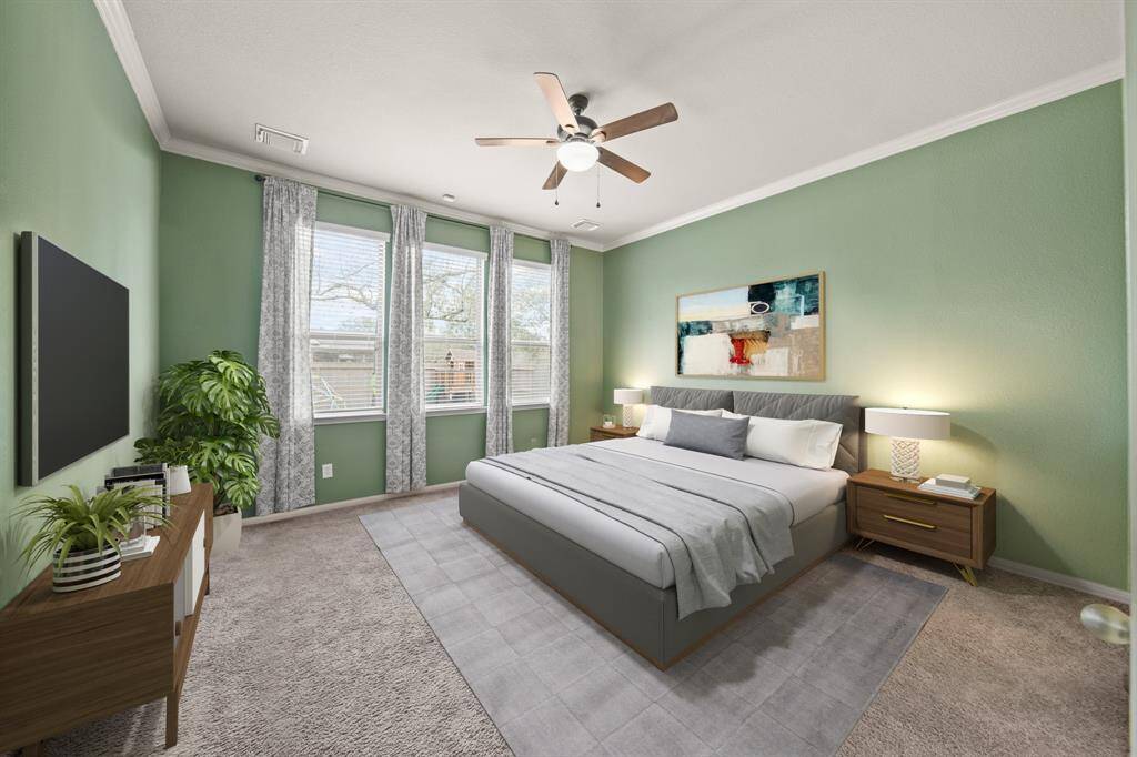 Virtually Staged: Unwind after a long day in this incredible primary bedroom! Featuring lots of natural light, carpet floors, privacy blinds, crown molding detilans, and a ceiling fan.