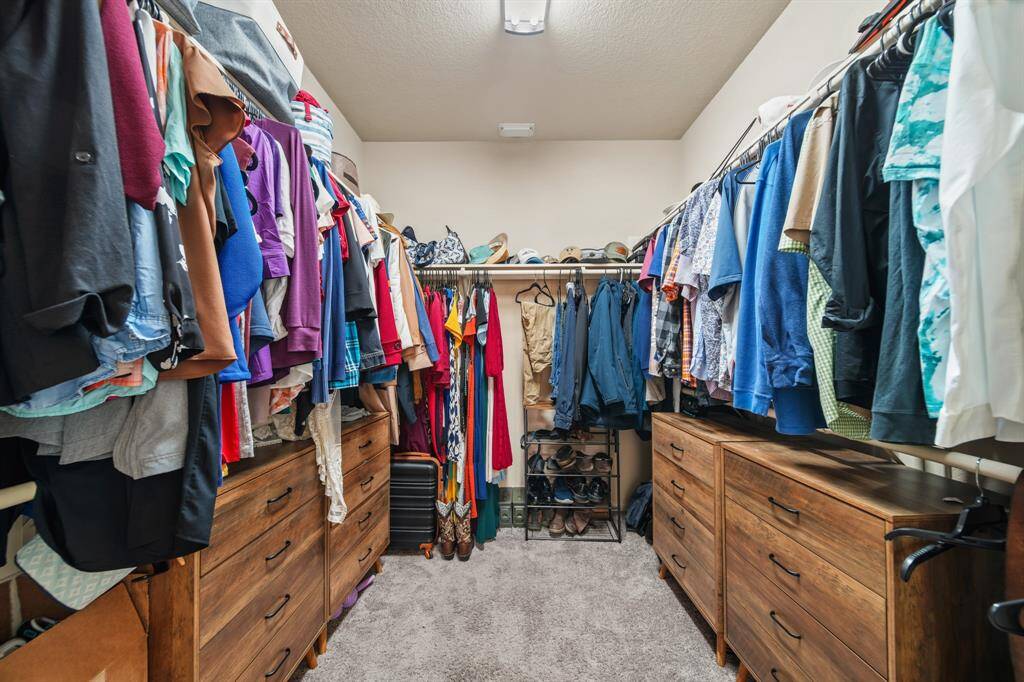The walk-in closet inside this primary bathroom is very spacious.