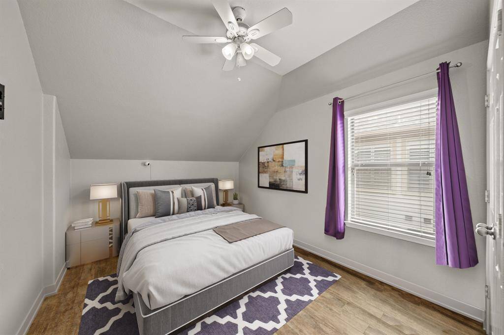 Virtually Staged: Secondary bedroom with wood floors, a vaulted ceiling with a ceiling fan, and a window with privacy blinds.