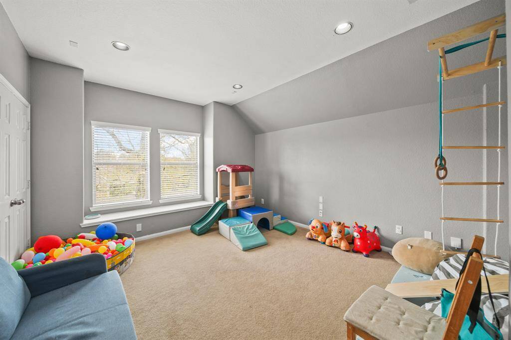 Bonus room with carpet floors, large windows with privacy blinds, and recessed lighting. This can become an additional secondary bedroom, but it is also wired for a media room so it can become such a great room for entertainment.
