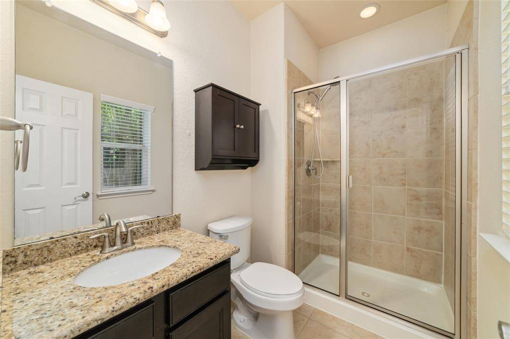En-suite bathroom with standing shower.