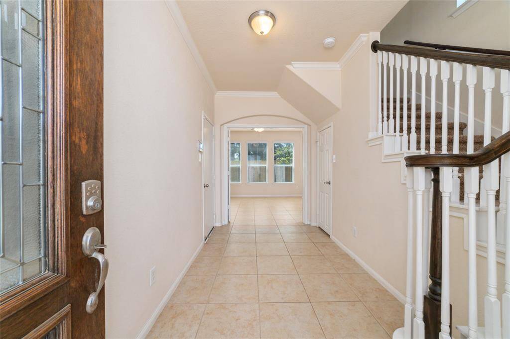 Formal entryway into the home with large bedroom and en-suite bathroom on first floor.