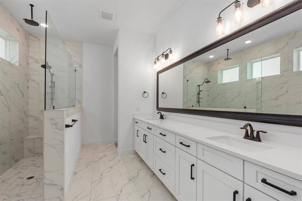Sparkling Primary bathroom with dual vanities and upgraded Super Shower!