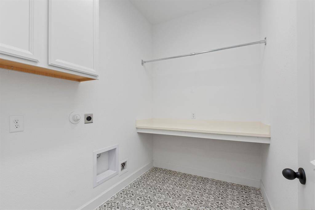 Large utility room with cabinets and countertop