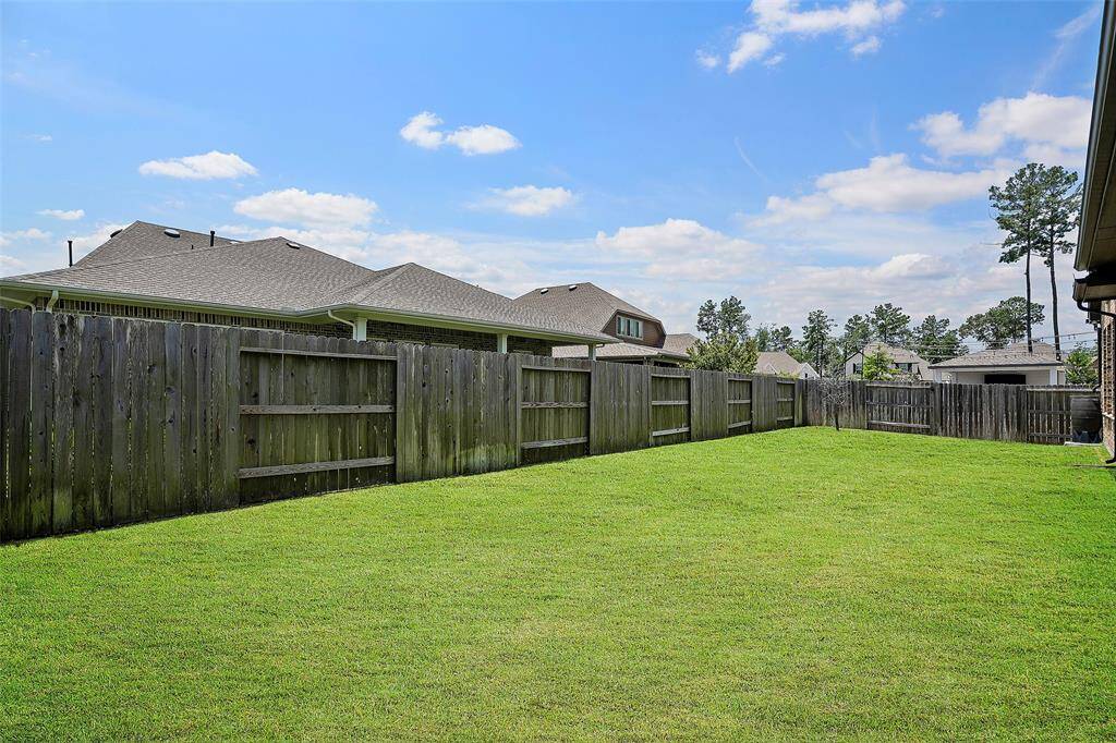 Fully fenced backyard with sprinkler system in front & back