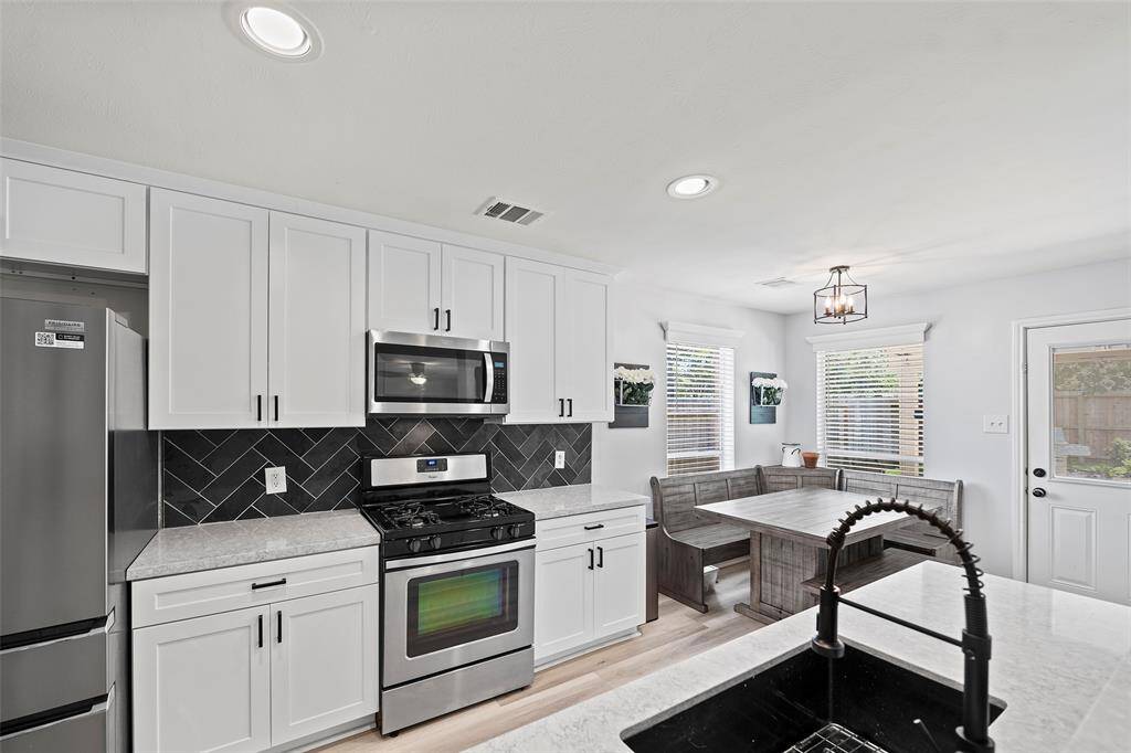 This kitchen features stainless appliances including a range with a gas cooktop!