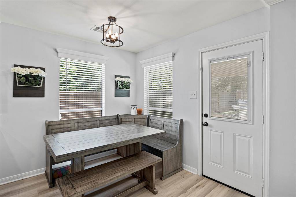 A charming breakfast room sits and waits for mornings of coffee and chatter in this sunny space!