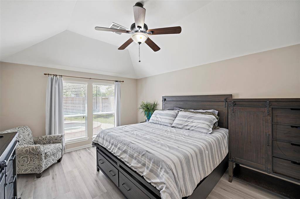 A peaceful primary bedroom will definitely offer relaxing slumber with its vaulted ceilings, large picture window with views, and neutral tones to settle the mind.