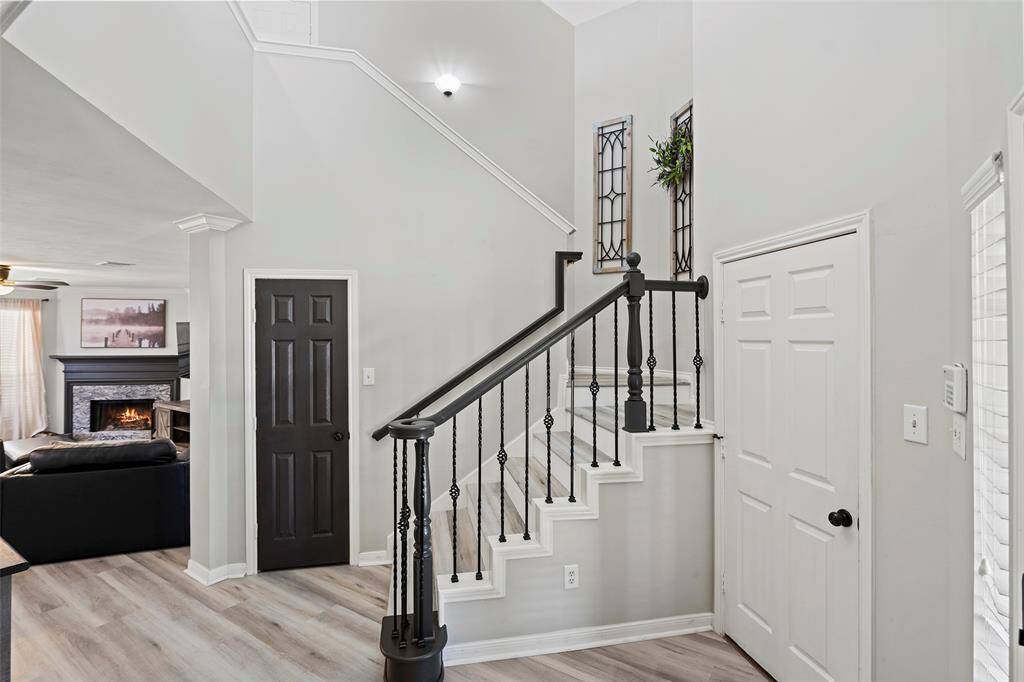 Let's travel up the gorgeous wrought iron staircase adorned w/luxury vinyl treads to the secondary living spaces!