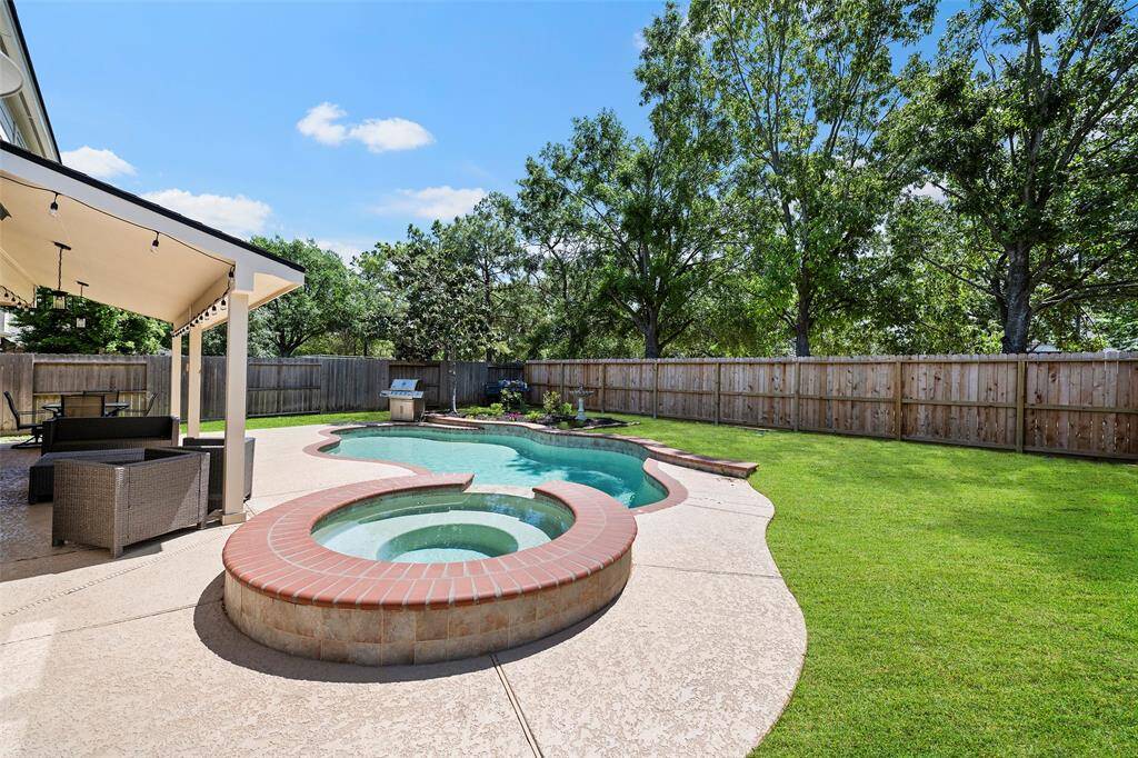 Mature trees line the recently installed fence filling the space with added privacy!  Imagine evenings sitting in the spa looking up at the stars in the night sky, or days floating in the pool drifting in and out of sleep with your toes in the cool water...sounds amazing, doesn't it?