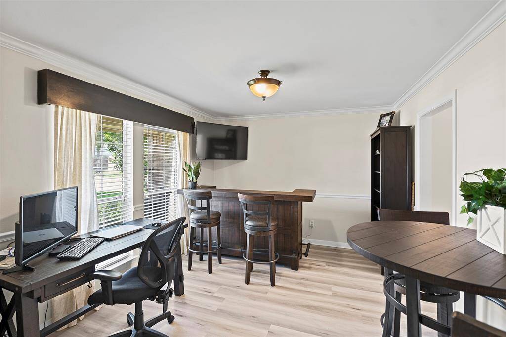 Off the entry, you will find this large space that has endless possibilities! Currently being used as a home office with bar area, it could easily transform to a formal dining room with direct access to the kitchen, home office or whatever you desire!