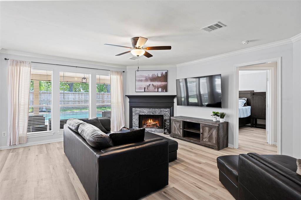 A wall of windows offers natural light along with views of the backyard oasis! This home has extensive crown just adding to the wonderful details that can be found throughout the home!  This home's interior was freshly painted in 2023, making it move-in ready!