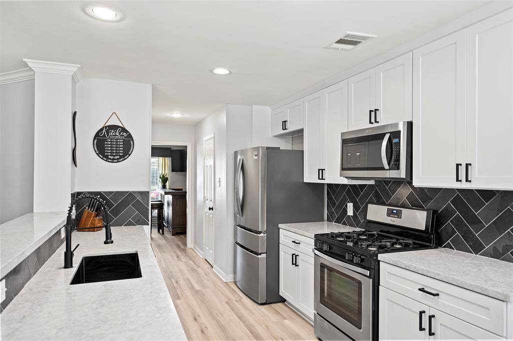 A showstopper kitchen awaits the chef of the home. Gorgeous Quartz countertops sit atop crisp white cabinets with a custom backsplash!