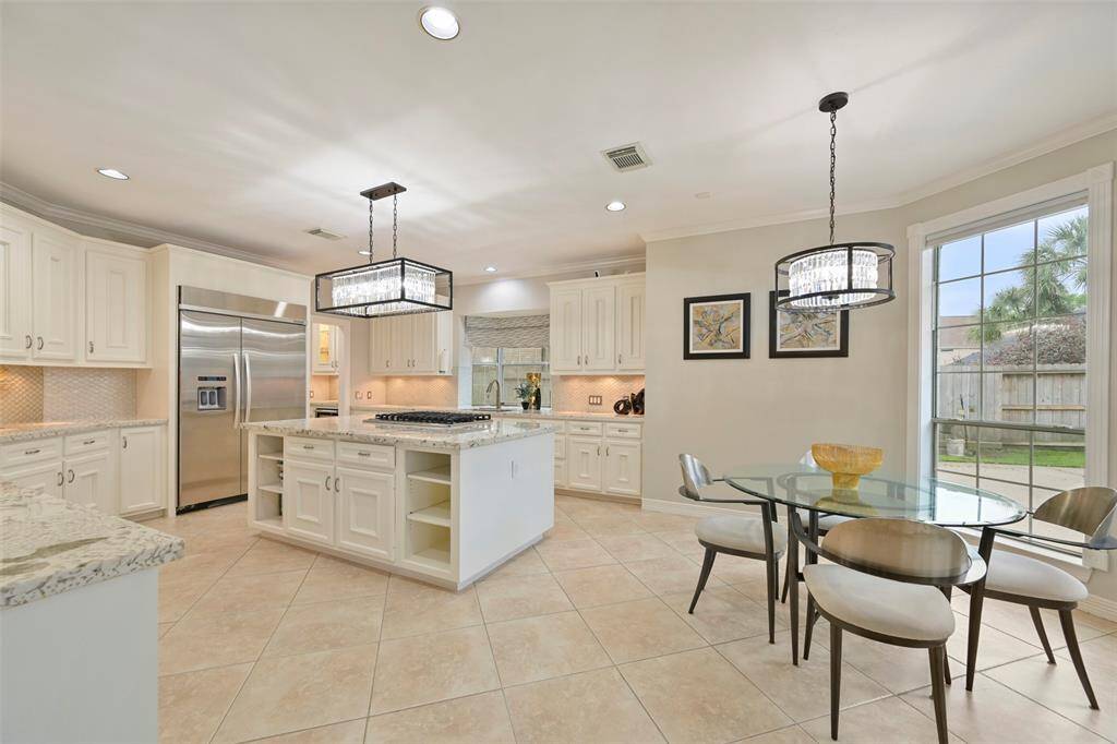 Spacious Breakfast area is open to the kitchen and the cozy Family room. Large windows offer plenty of natural light and a view of the backyard.