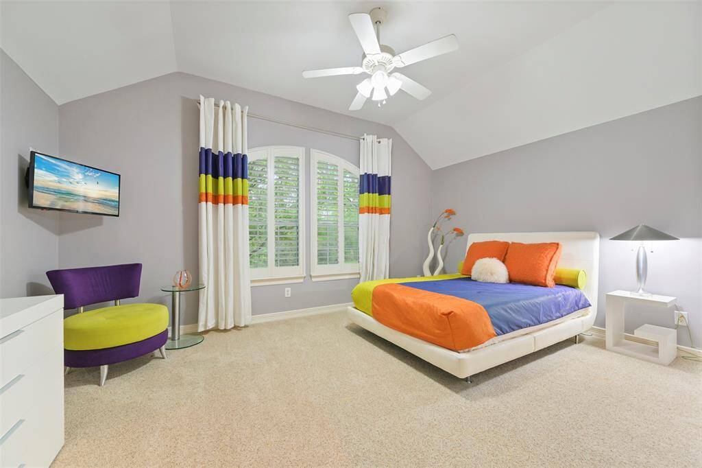 This spacious Secondary bedroom or guest bedroom on the second floor is light and bright and features a vaulted ceiling, large window with plantation shutters overlooking the front. This room also features a large walk-in closet.