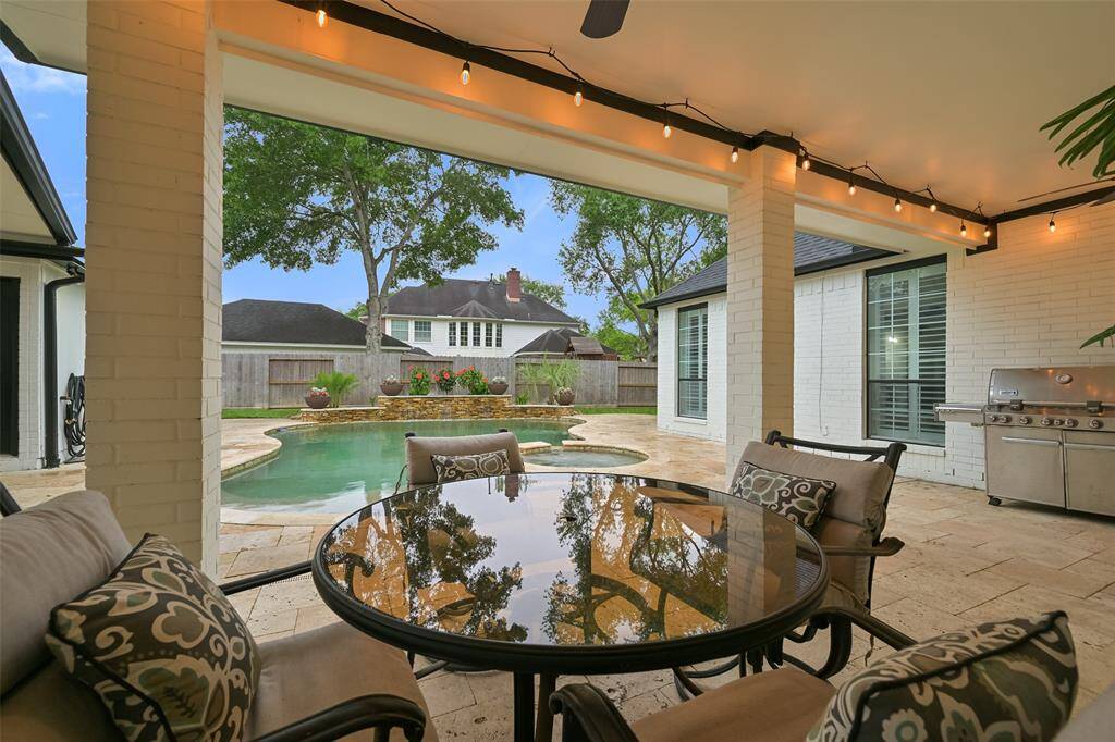This inviting covered outdoor patio offers a serene retreat overlooking the sparkling pool/spa and beautifully landscaped backyard. This patio is a true extension of the home's living space-ideal for enjoying both sunny afternoons and peaceful evenings by the pool.