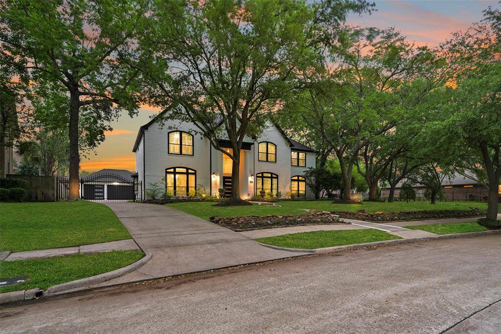 Another view of this beautifully updated home featuring the detached, oversized 3-car garage and an automatic gate.
