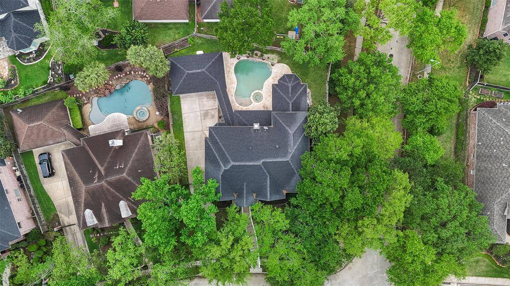 An aerial shot of the house with ample green space on each side of the house.