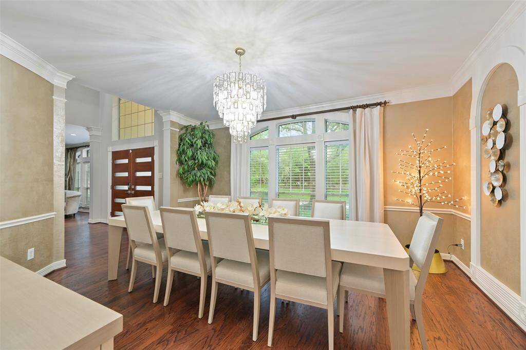 This spacious formal dining room features hardwood floors, accent walls, large windows overlooking the front yard.