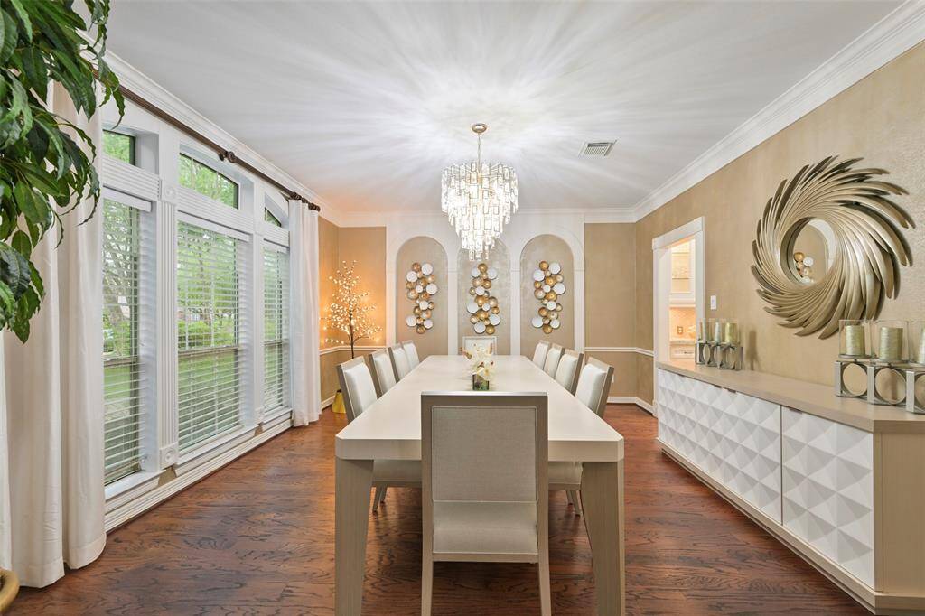 Another view of the spacious Formal Dining room with wall of windows overlooking the front yard and is open to the Butler's pantry.