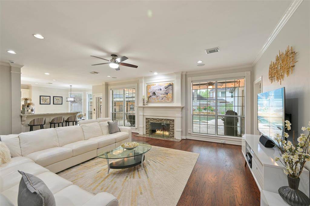 This spacious family room features a cozy gas fireplace, elegant hardwood floors, and ample natural light from large windows overlooking the beautifully landscaped backyard, pool and spa. The open layout connects seamlessly to the kitchen and the breakfast areas, creating a perfect space for informal gathering and entertaining.