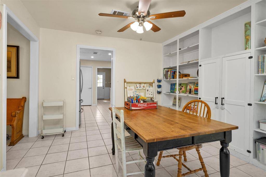 Dining room with wall of built-ins used as a home office