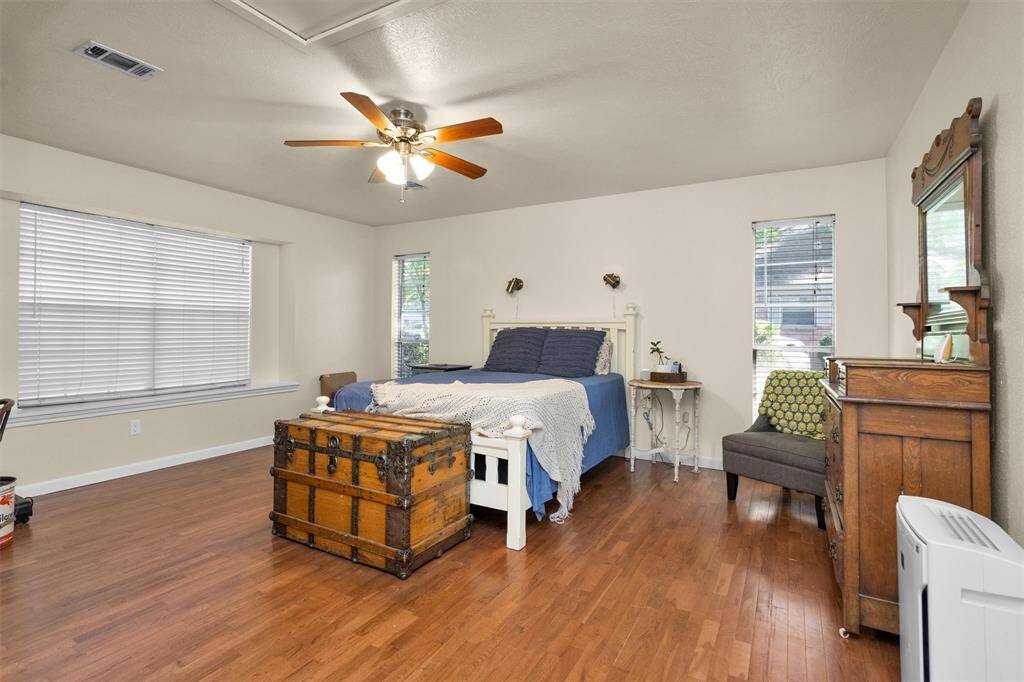 Primary suite downstairs with beautiful wood floors