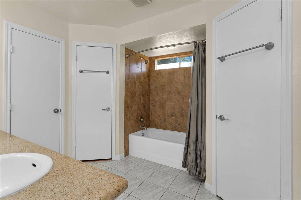 Primary bathroom with his'n'hers closets