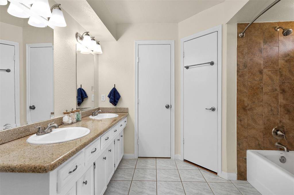 Double sinks with granite counters. Separate toilet with door.