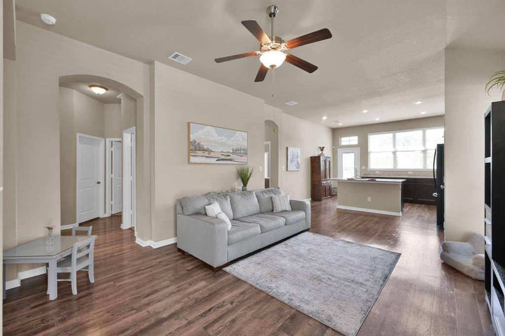 A look into the hallway which holds 2 bedrooms, full bathroom, laundry room and storage/coat closet. Closed door pictured is the bedroom being used for storage currently