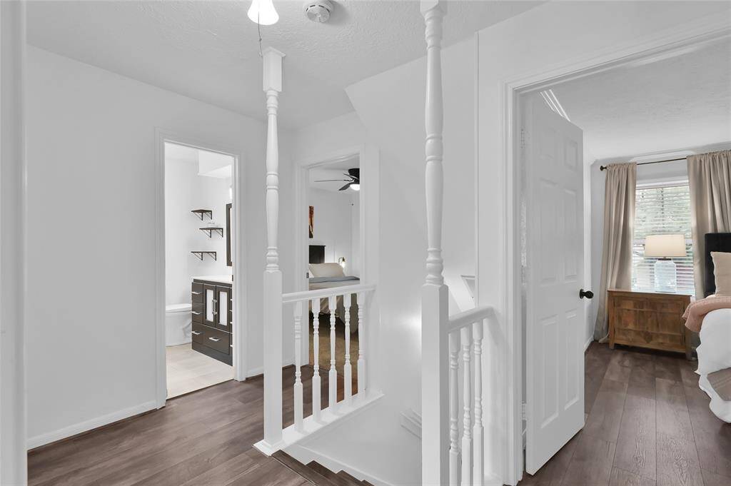 At the top of the stairs, you have access to all four Bedrooms and two full Bathrooms. The upstairs Hallway also has laminate wood flooring.