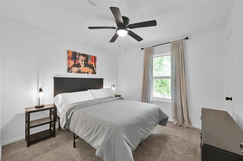 The third Secondary Bedroom overlooks the Front Yard, has a ceiling fan with light and a light plaster treatment applied to the walls adding a decorative touch.