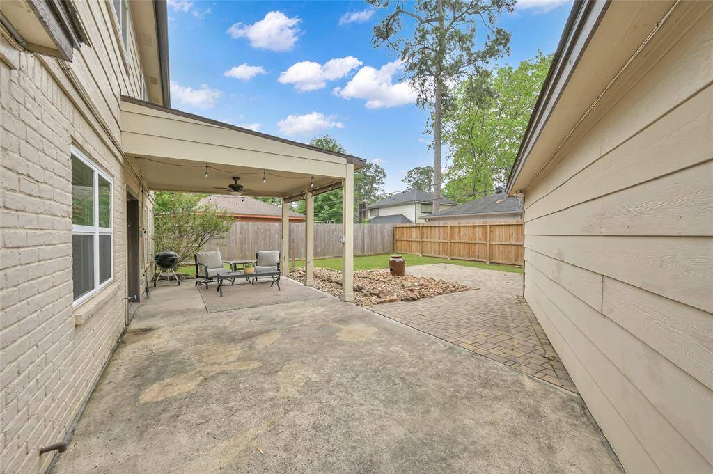 The covered patio extends with more patio and the additional brick paver patio.