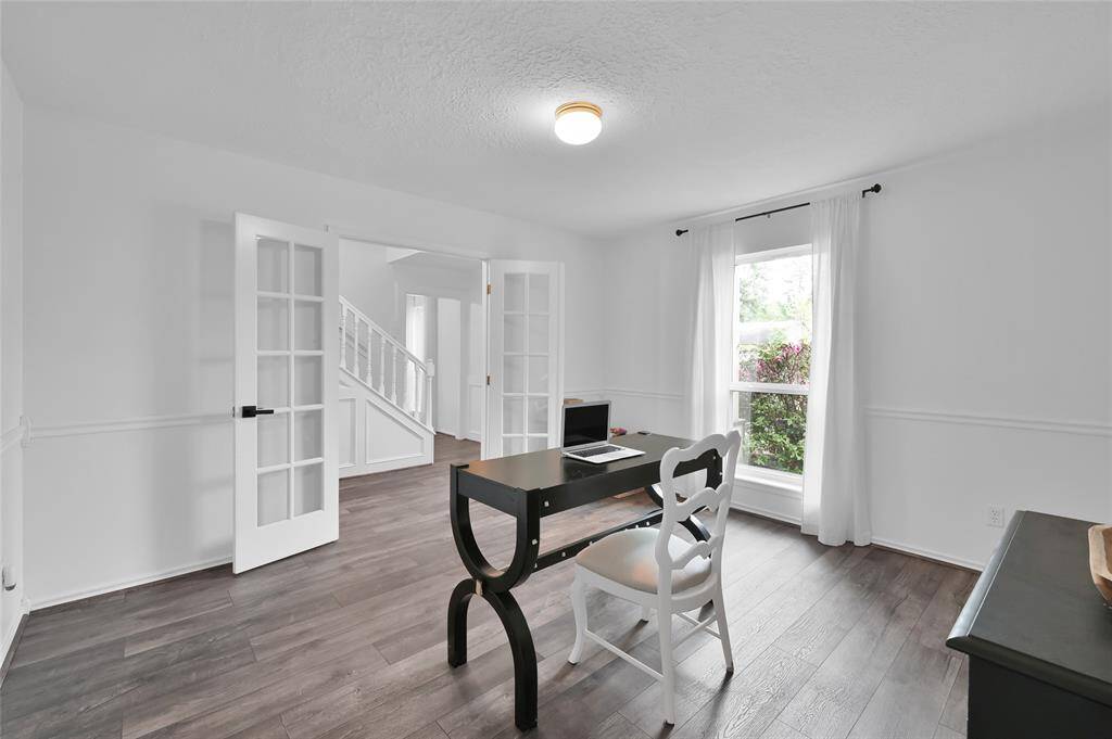 To the left of the Foyer is the Study overlooking the beautiful front yard with glass panel French doors and wood laminate flooring. Located at the front of the home, this room provides quiet and privacy.