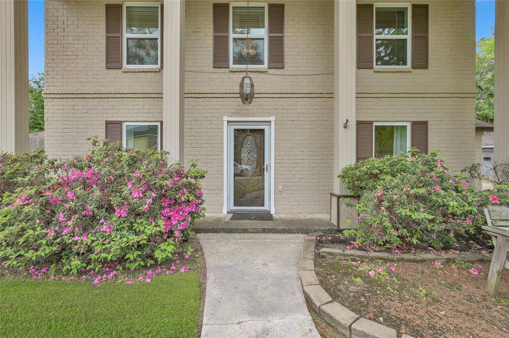 Front Yard has established Azaela bushes, mature trees and a covered porch for enjoying pleasant days. The seller is even going to leave the park bench for you!