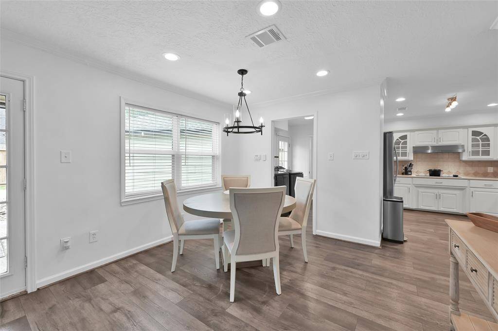 Double pane windows provide a great view of the Back Yard. This area also has an updated light fixture and faux wood blinds when you desire more privacy.