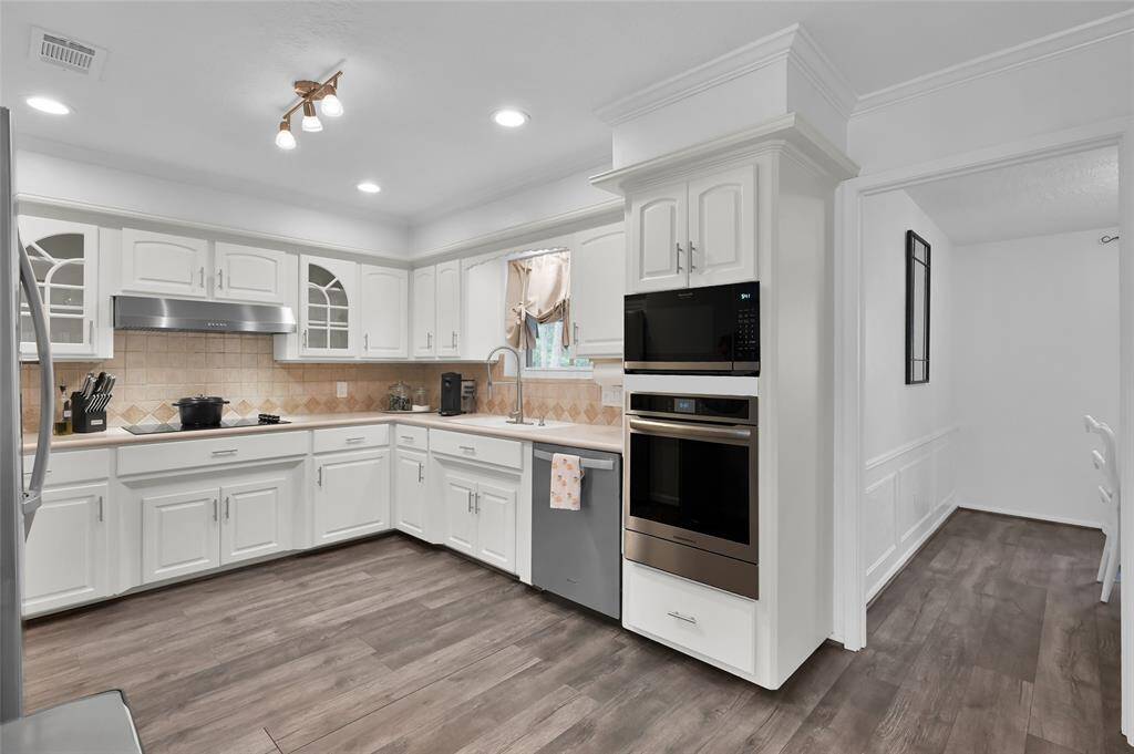 The Kitchen with a new Frigidaire Microwave and Oven (April 2025) also has an updated light fixture and cabinet and drawer hardware.