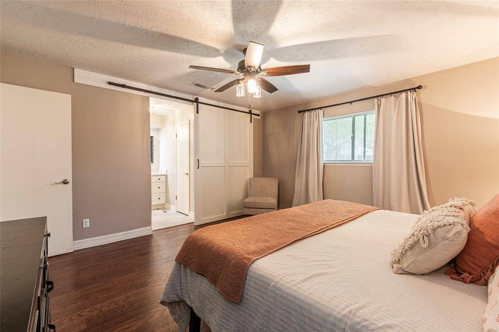 Sliding barn door leads into primary bath