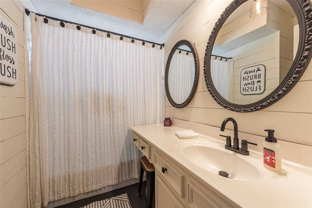 2nd bath down with shiplap walls