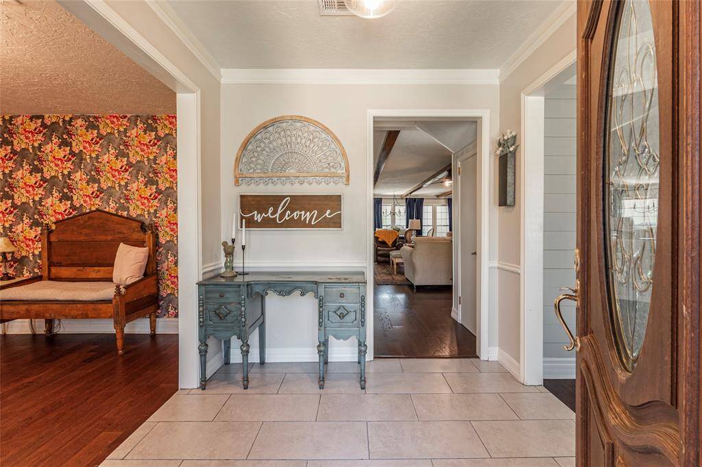 Entry with living room on left, dining on right