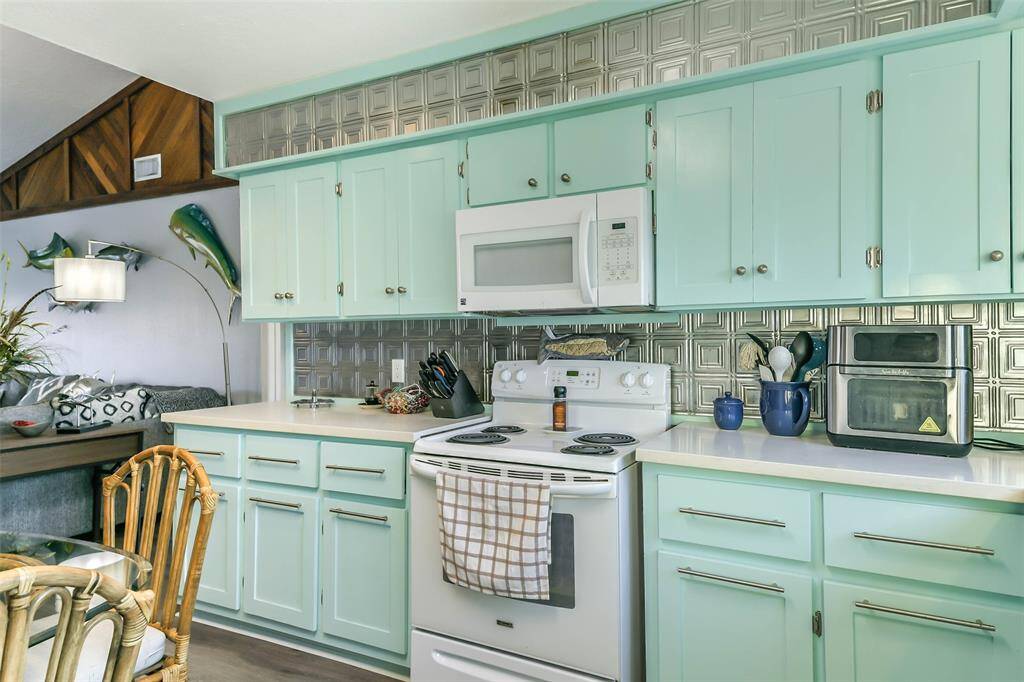Equipped with a built-in oven, stove, and microwave, this kitchen offers ample cabinet space for all your storage needs.