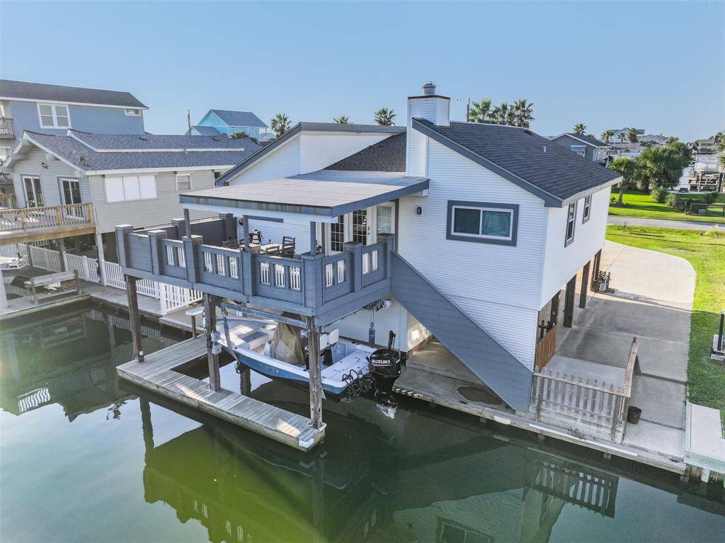Home situated on a canal with direct access to Galveston Bay, featuring a bulkhead and a boat lift for your convenience..