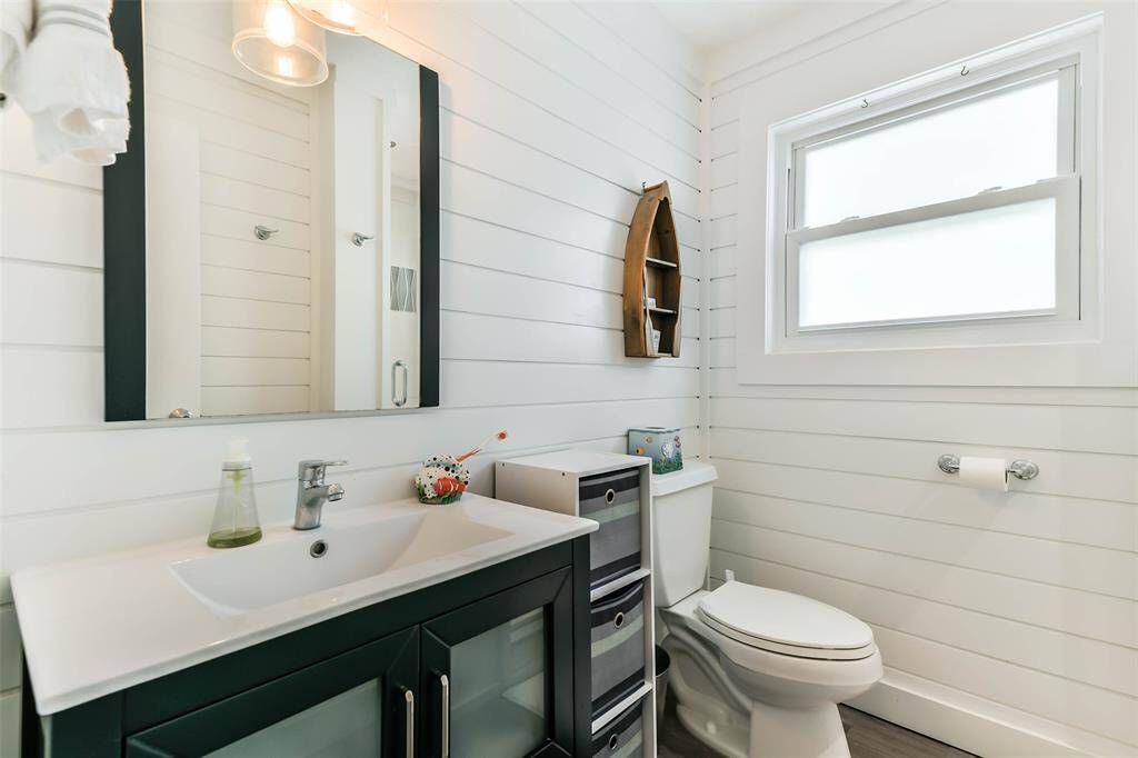 The hallway features a full bathroom equipped with a convenient walk-in shower.