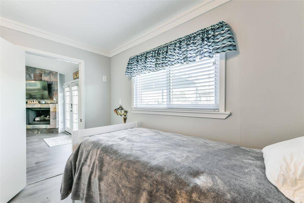 The laundry room is located to the left of the patio entrance, featuring a daybed that serves as an additional fourth bedroom.