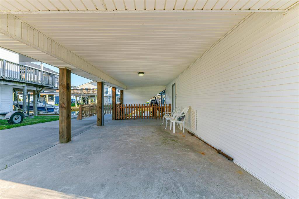 Carport leading to the garage and workshop entrance.