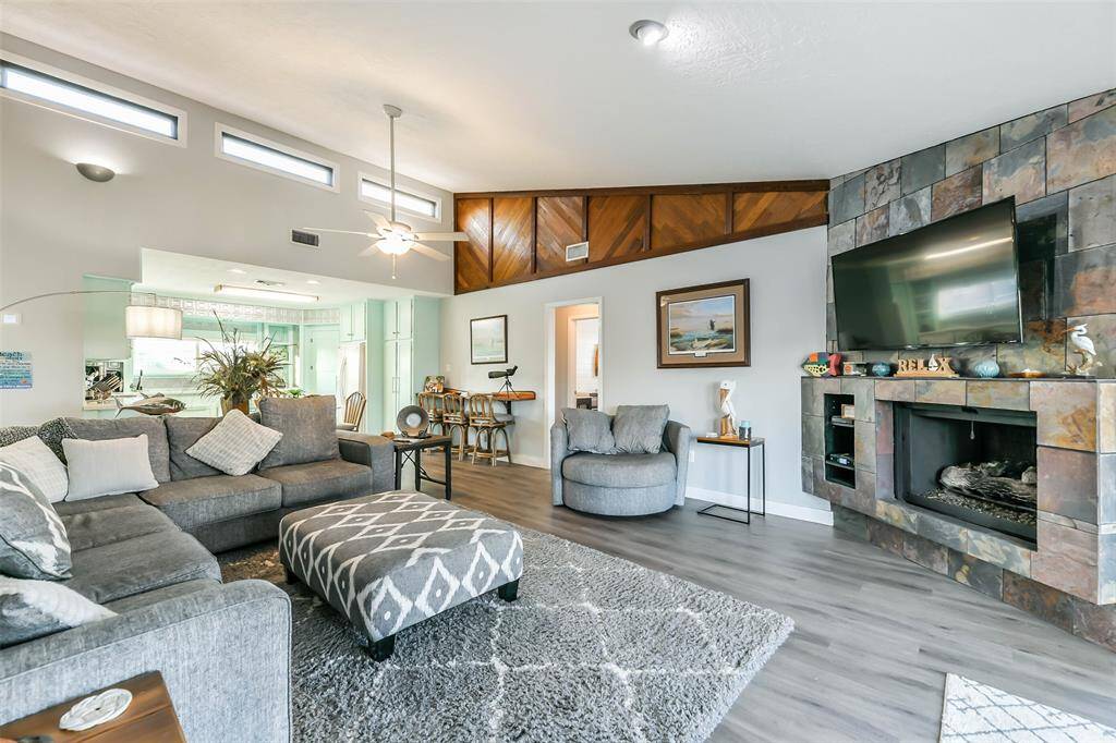 The family room features a slate-accented fireplace, complete with a gas log insert for a cozy ambiance.