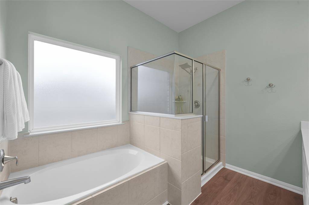 At the end of the day, relax in your soaking tub or take a long shower. Your skin will appreciate the Kinetico 735 Signature Series Water Softener as will your dishes and laundry since it covers the entire interior of the home. You can even watch a show with the wall-mounted ROKU TV out of view in this photo.